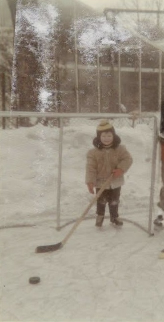 Ian McIvor as a child, playing hockey on a backyard rink
